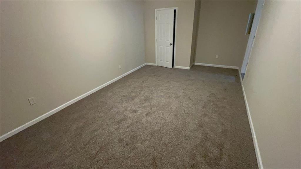 3766 Chimney Ridge Court Ellenwood, GA 30294 - Photo 4 of 9 an empty room with an entryway