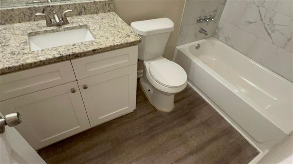 3766 Chimney Ridge Court Ellenwood, GA 30294 - Photo 5 of 9 a bathroom with a granite countertop sink and a toilet