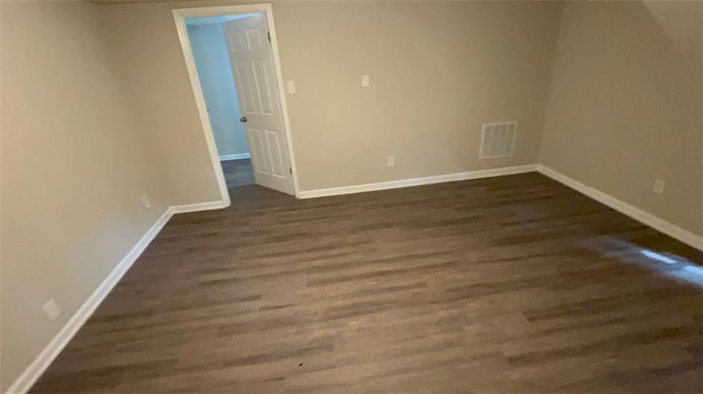 3766 Chimney Ridge Court Ellenwood, GA 30294 - Photo 6 of 9 an empty room with wooden floor and entrance