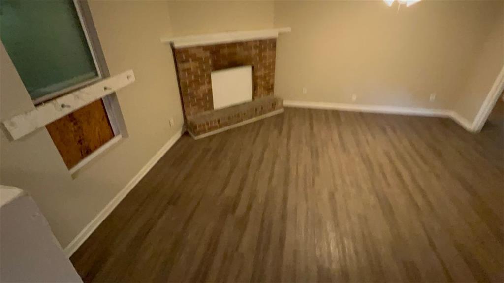 3766 Chimney Ridge Court Ellenwood, GA 30294 - Photo 7 of 9 a view of an empty room with wooden floor and a window