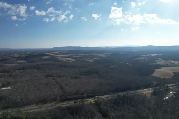 a view of city and mountain in the distance in a field