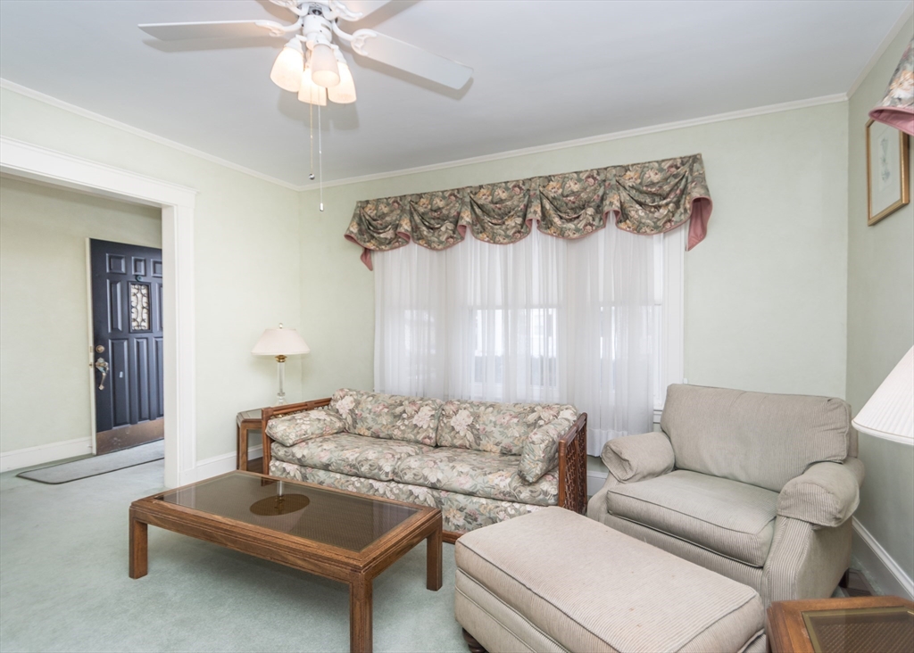 279-281 Ash Street Waltham, MA 02453 - Photo 14 of 39 a living room with furniture and a window