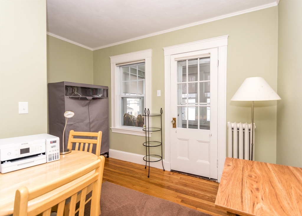 279-281 Ash Street Waltham, MA 02453 - Photo 21 of 39 a bedroom with a bed and wooden floor