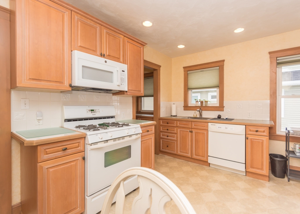 279-281 Ash Street Waltham, MA 02453 - Photo 22 of 39 a kitchen with a stove top oven sink and cabinets