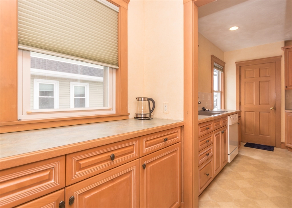 279-281 Ash Street Waltham, MA 02453 - Photo 24 of 39 a bathroom with a double vanity sink a mirror and a bathtub