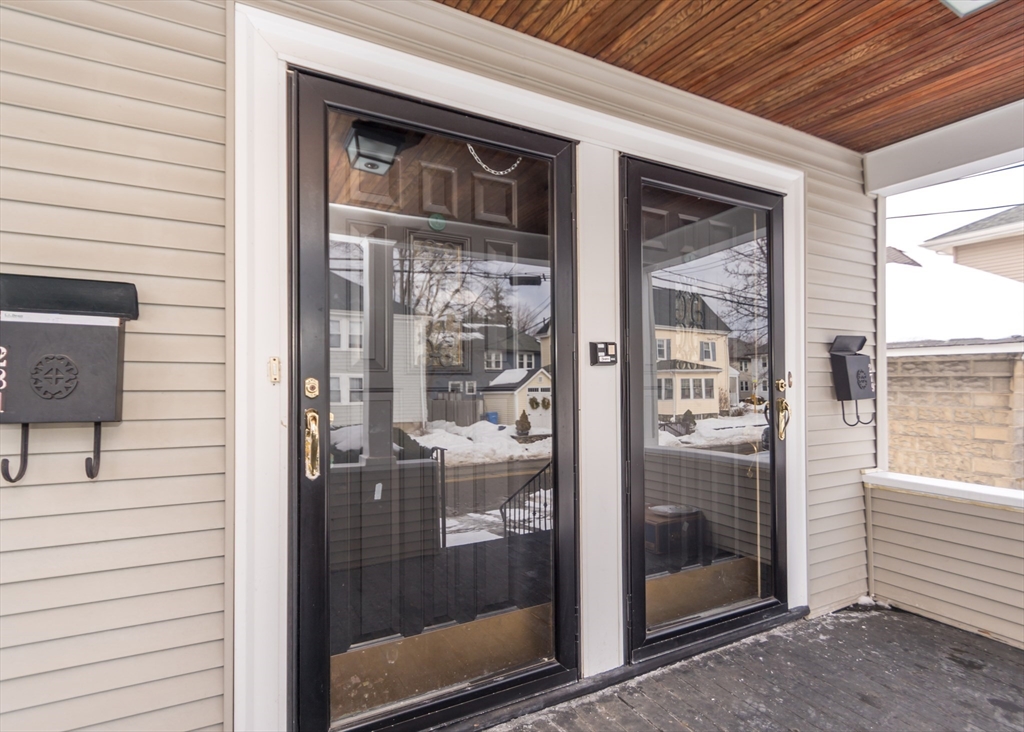 279-281 Ash Street Waltham, MA 02453 - Photo 3 of 39 a view of a glass door of the house