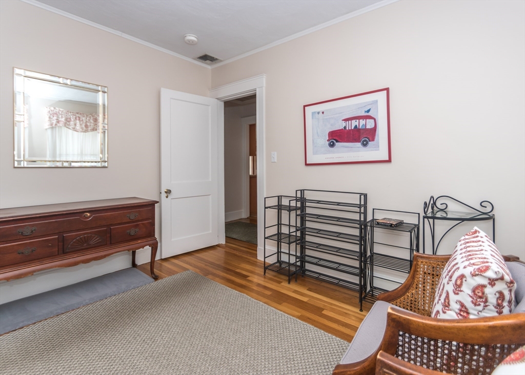 279-281 Ash Street Waltham, MA 02453 - Photo 36 of 39 a bedroom with furniture and a window