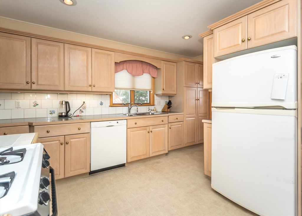 279-281 Ash Street Waltham, MA 02453 - Photo 5 of 39 a kitchen with white cabinets and white appliances