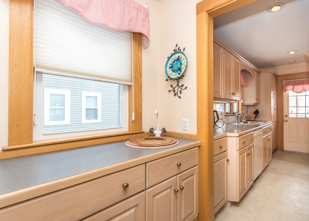 279-281 Ash Street Waltham, MA 02453 - Photo 7 of 39 a kitchen with stainless steel appliances granite countertop a stove a sink and a refrigerator