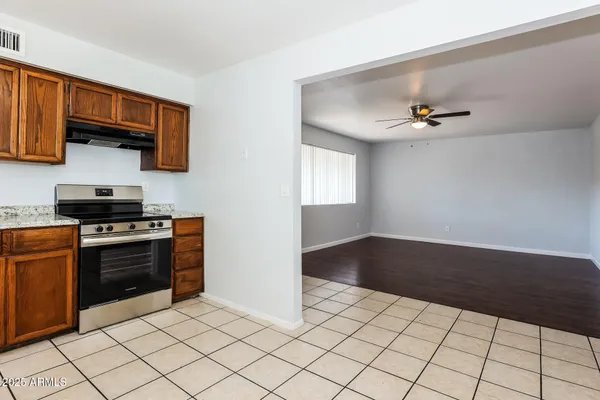 a kitchen with stainless steel appliances a sink stove and cabinets