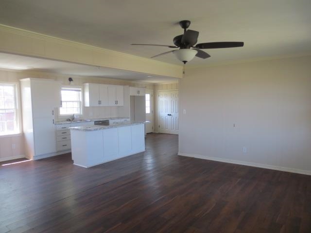 2930 Lovelace Crossing Road Henning, TN 38041 - Photo 5 of 16 Kitchen featuring ceiling fan, baseboards, white cabinetry, and a kitchen island