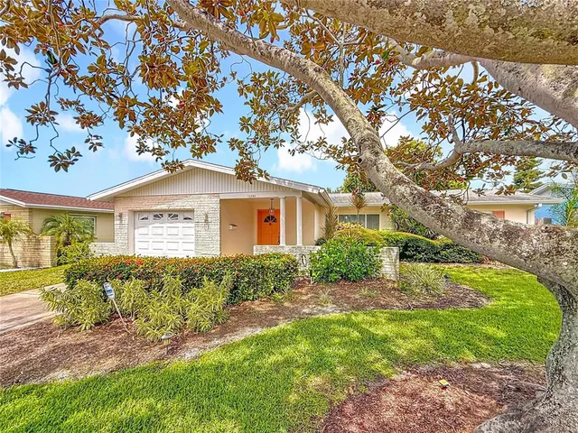 a front view of house with yard and green space