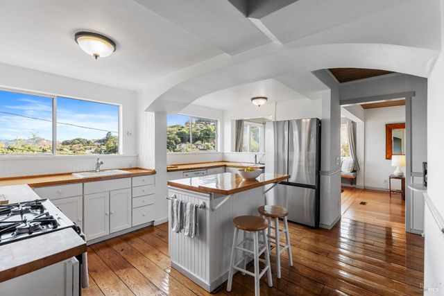 a kitchen with a stove a sink and a refrigerator