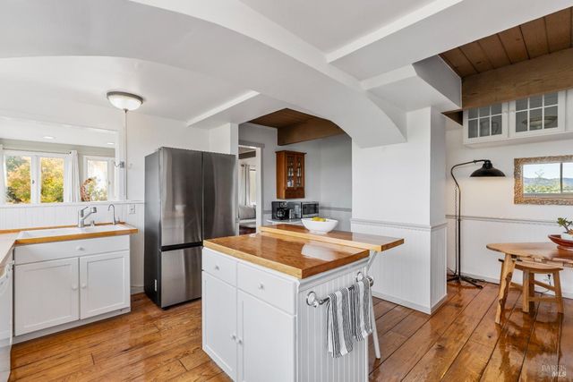 a view of a dining room with furniture and a chandelier