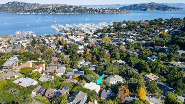 an aerial view of a houses with outdoor space and lake view