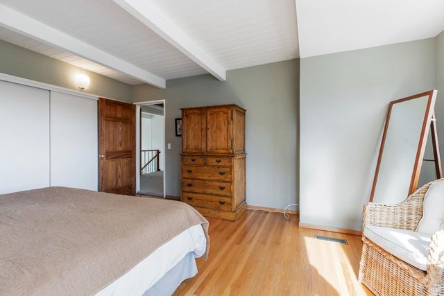 a bedroom with a bed and a night stand