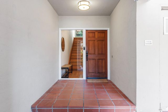 a view of a hallway with wooden floor and entryway
