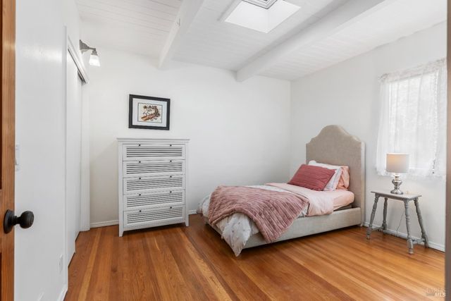 a kitchen with stainless steel appliances granite countertop a refrigerator a stove and a wooden floor