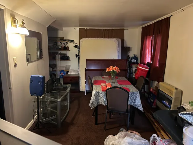 a dining room with furniture and a lamp