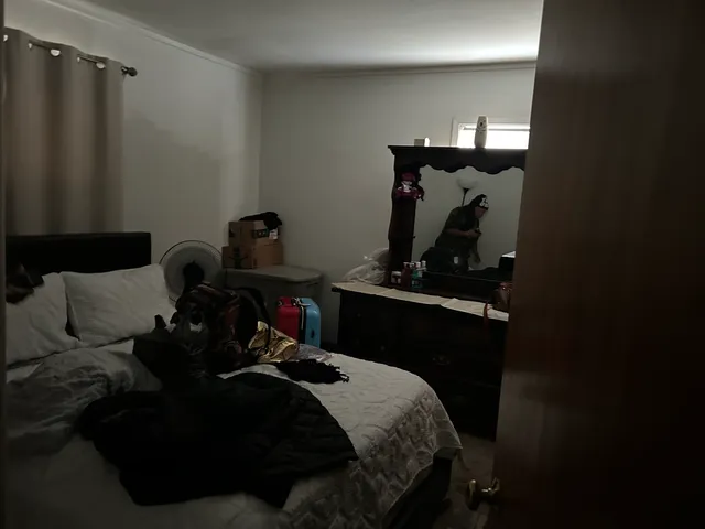 a bed sitting in a bedroom next to a window