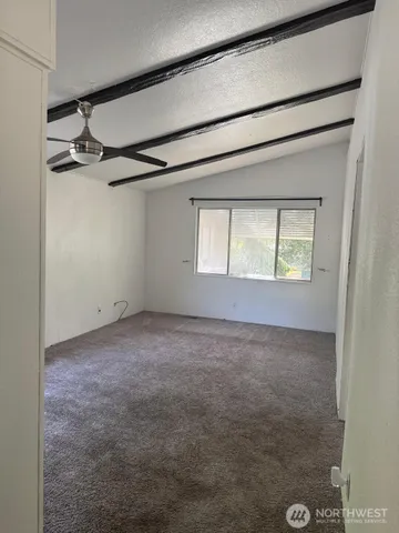 a view of an empty room with a window