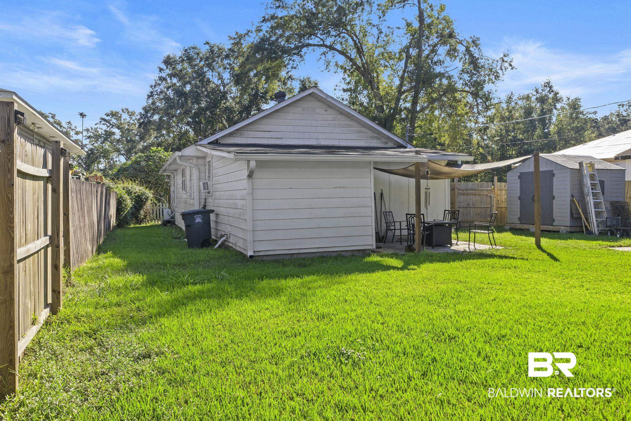 707 North Cedar Street Foley, AL 36535 - Photo 44 of 69 Rear view of property with a patio, a shed, and a yard