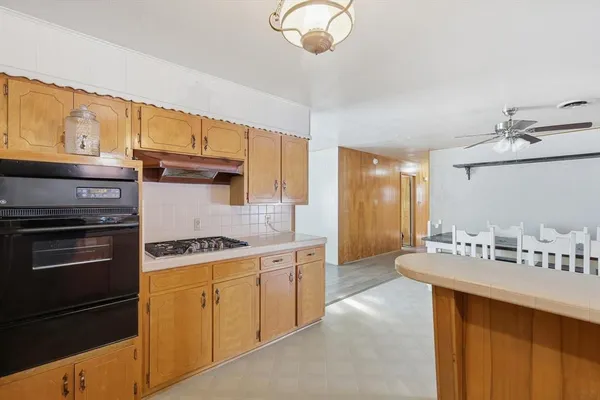 a kitchen with a sink stove and microwave