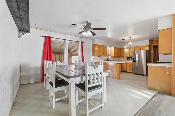 a view of a dining room with furniture and a kitchen
