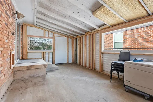 a view of workspace with furniture and large windows