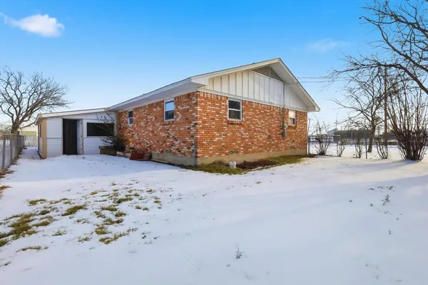 a view of a house with a snow on the road
