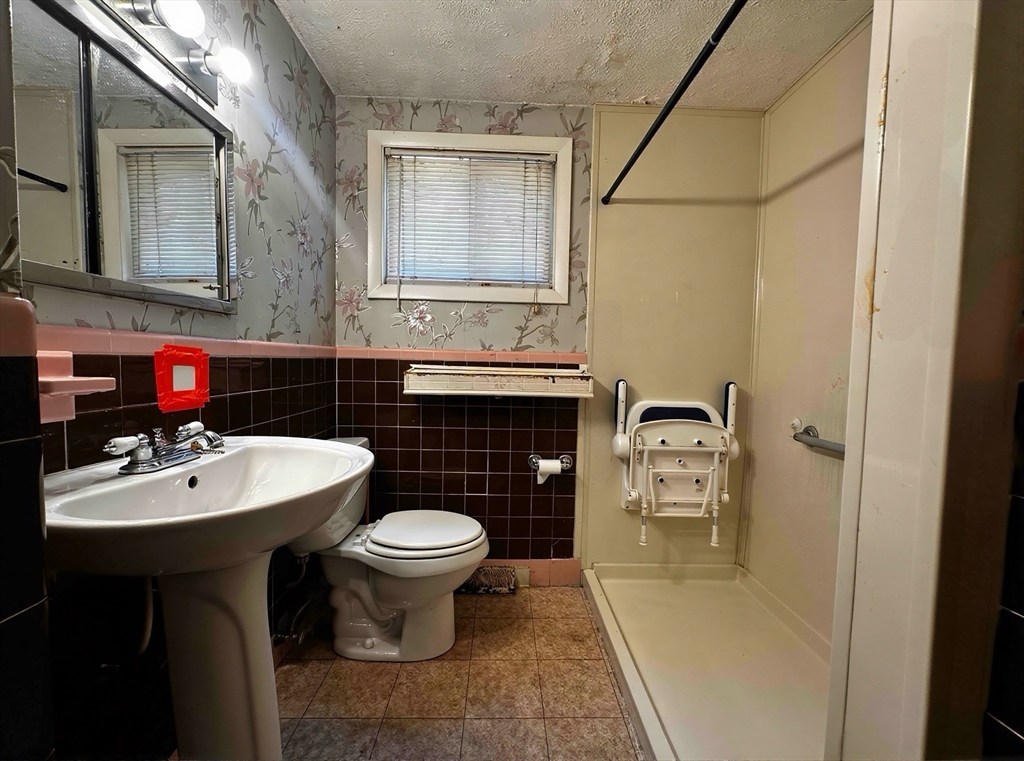 22 Corman Road Boston, MA 02126 - Photo 17 of 29 a bathroom with a sink toilet and shower