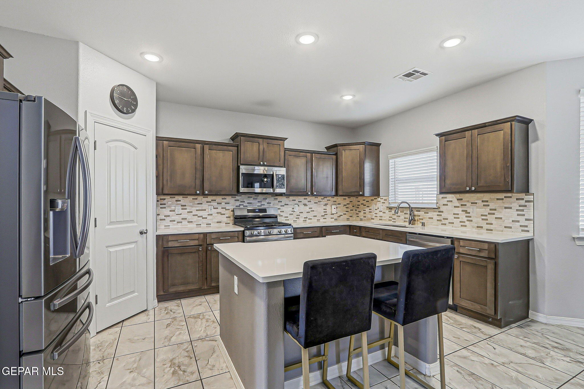 525 Issa Circle El Paso, TX 79932 - Photo 14 of 47 a kitchen with granite countertop a sink stove refrigerator and cabinets
