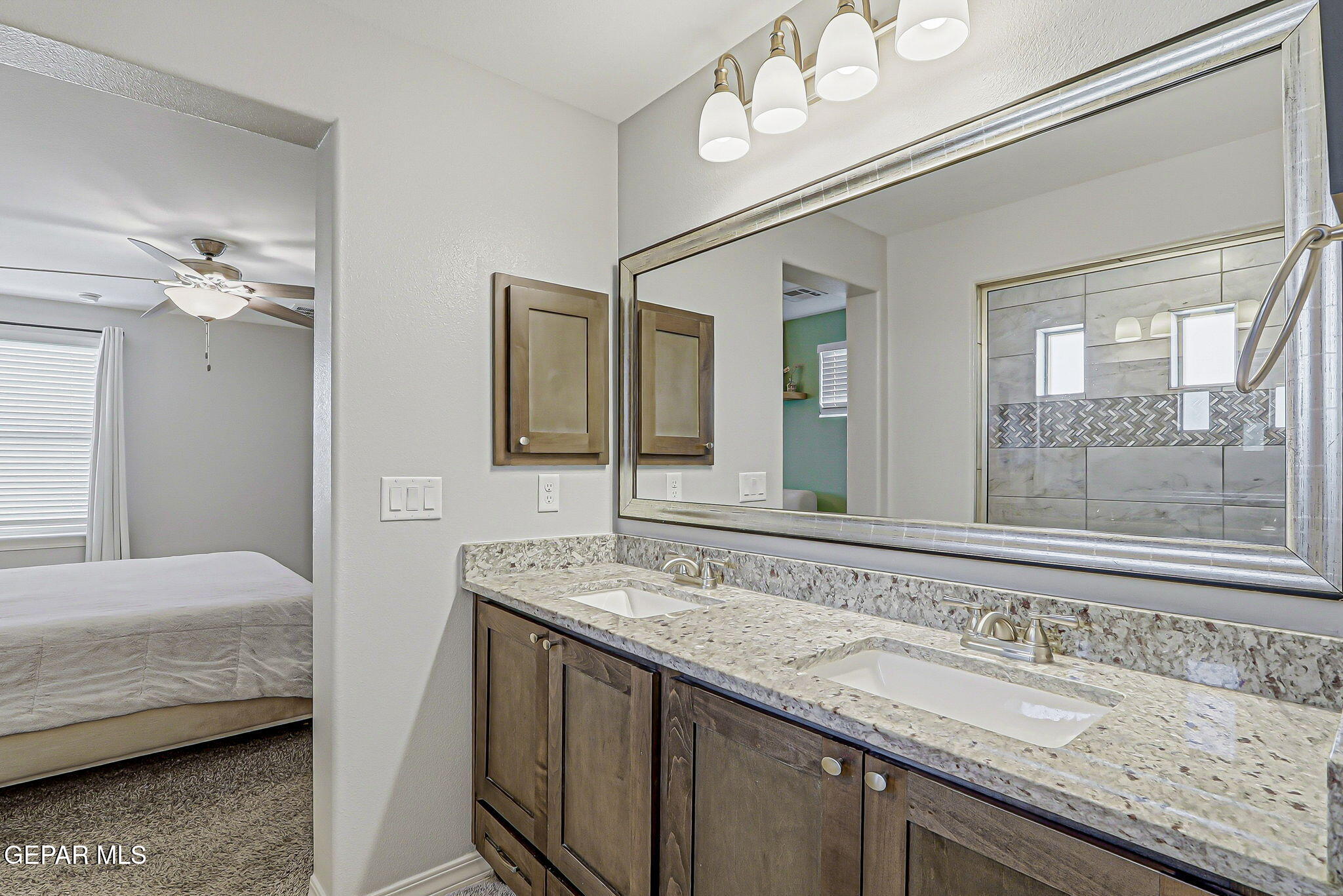 525 Issa Circle El Paso, TX 79932 - Photo 45 of 47 a en suite bathroom with a granite countertop sink and a mirror