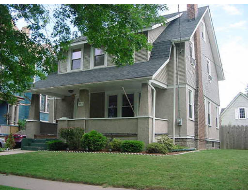 a front view of a house with a garden and plants