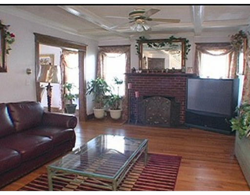 953 Sumner Avenue Springfield, MA 01118 - Photo 5 of 14 a living room with furniture and a fireplace