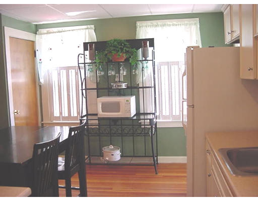 953 Sumner Avenue Springfield, MA 01118 - Photo 6 of 14 a kitchen with a refrigerator and a cabinets