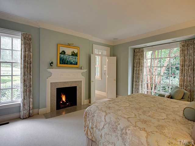 1908 Chase Court Raleigh, NC 27607 - Photo 14 of 25 a bedroom with a bed and a fireplace
