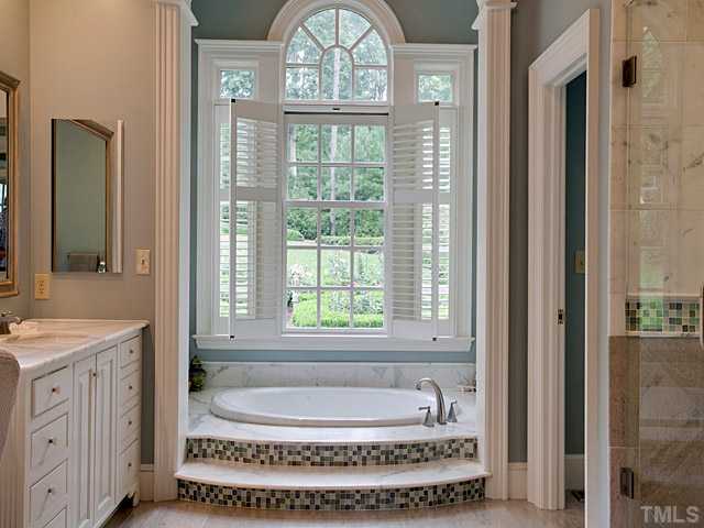 1908 Chase Court Raleigh, NC 27607 - Photo 17 of 25 a bathroom with a tub a sink and a window