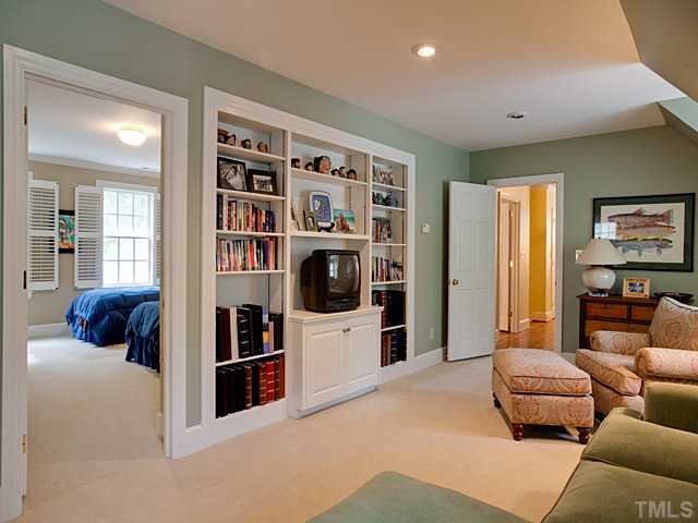 1908 Chase Court Raleigh, NC 27607 - Photo 19 of 25 a bedroom with furniture and a book shelf