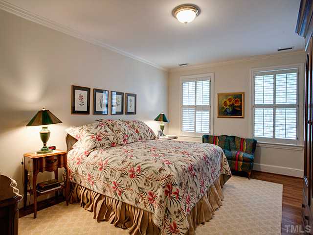 1908 Chase Court Raleigh, NC 27607 - Photo 20 of 25 a bedroom with a bed and wooden floor
