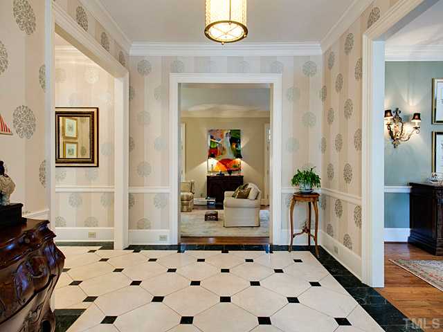 1908 Chase Court Raleigh, NC 27607 - Photo 3 of 25 a hallway with a black white checkered floor and a potted plant