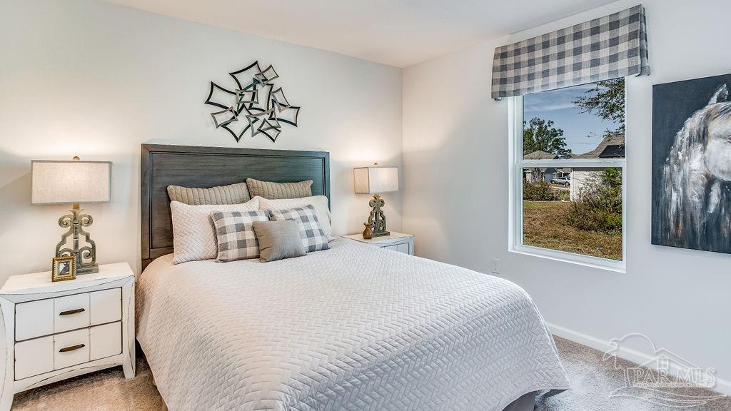 5084 Rainwater Road Milton, FL 32583 - Photo 24 of 26 a bedroom with a bed and a painting on the wall