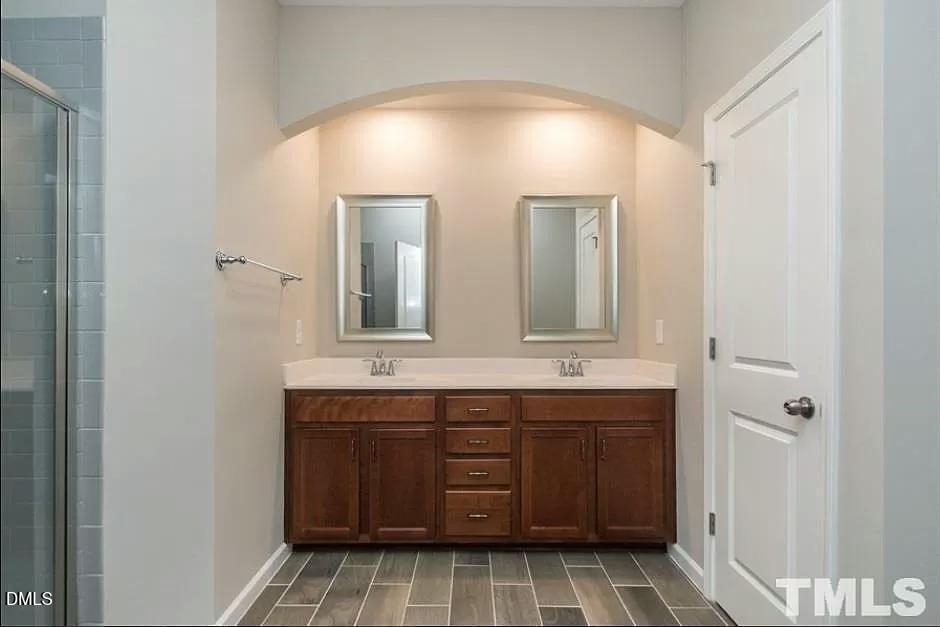 1142 Lookout Ridge Road Apex, NC 27502 - Photo 12 of 21 a bathroom with a double vanity sink and mirror