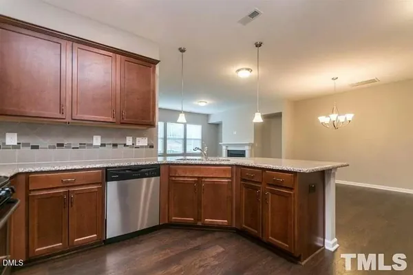a kitchen with sink cabinets and wooden floor