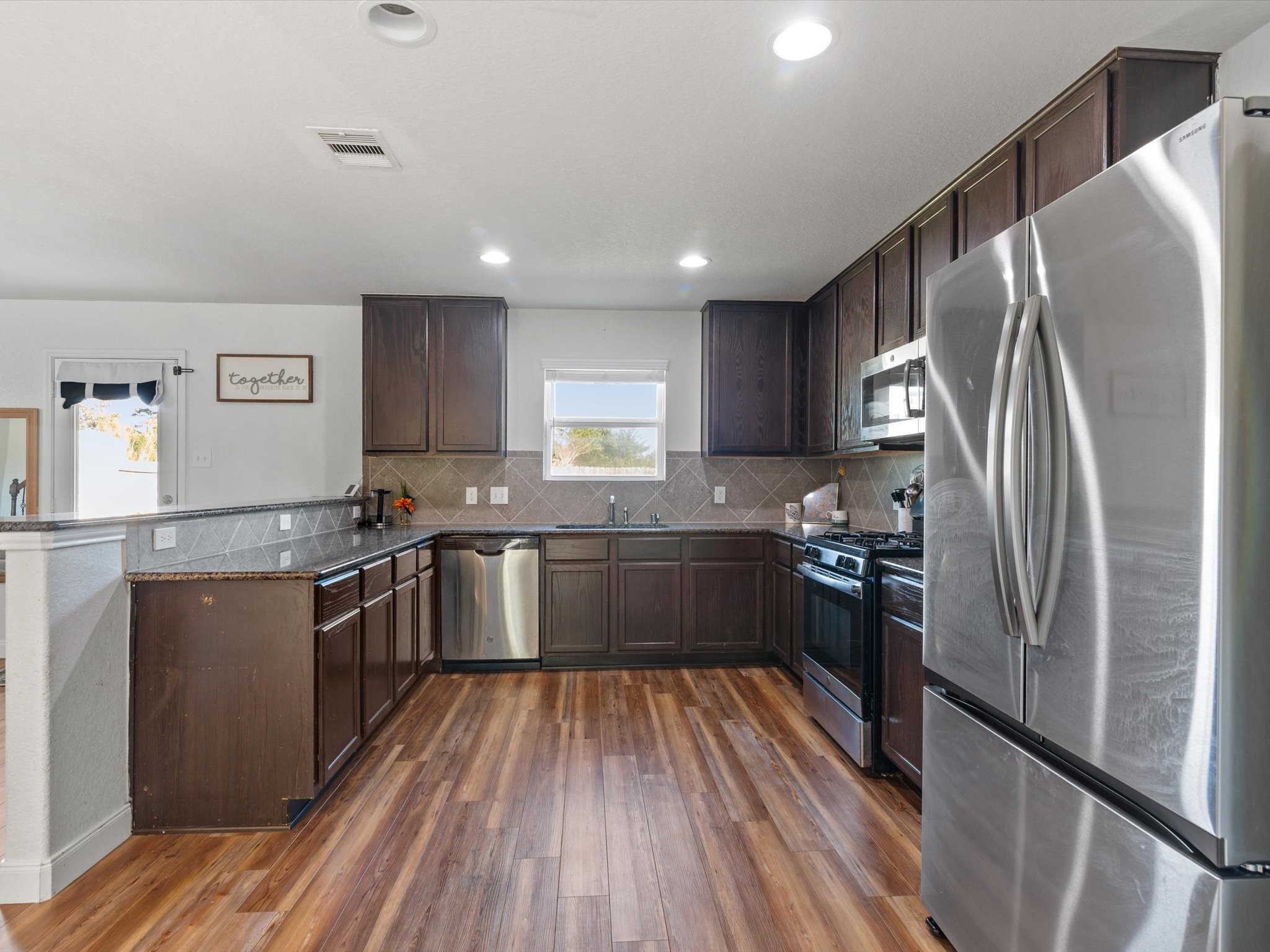 2535 Zephyr Lane Rosenberg, TX 77471 - Photo 20 of 40 a kitchen with granite countertop a refrigerator stove top oven and sink