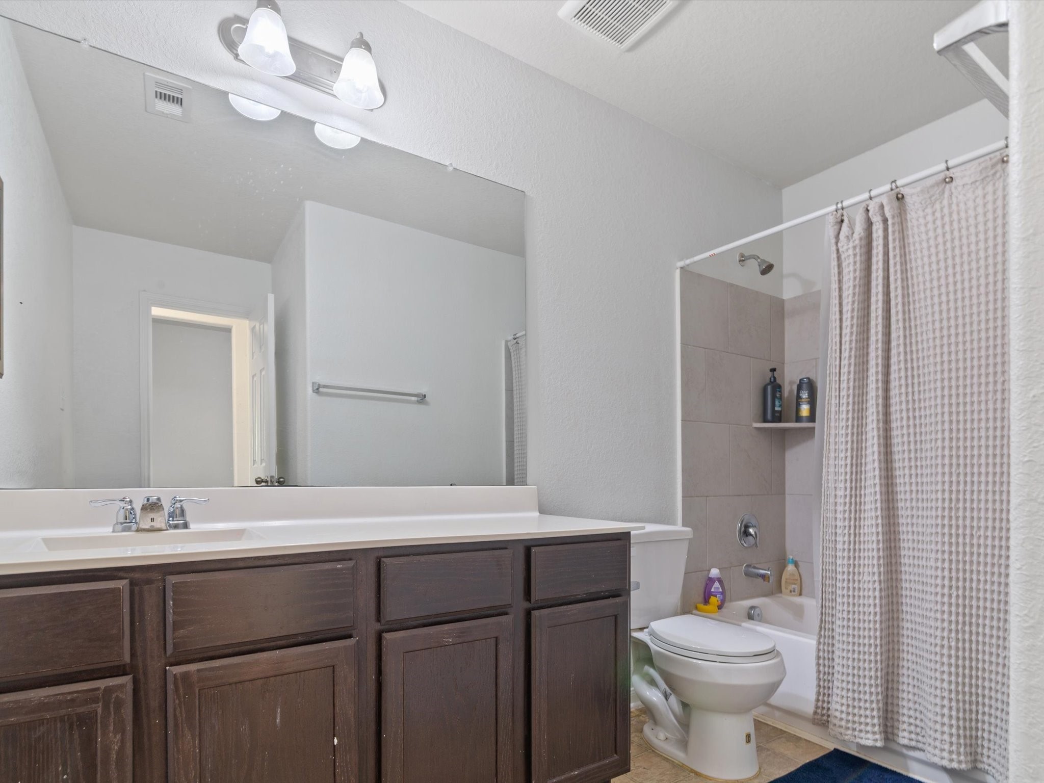 2535 Zephyr Lane Rosenberg, TX 77471 - Photo 27 of 40 a bathroom with a double vanity sink mirror and toilet