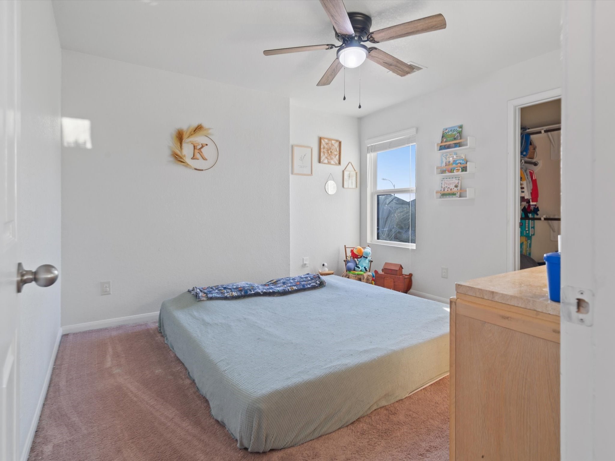 2535 Zephyr Lane Rosenberg, TX 77471 - Photo 31 of 40 a bedroom with a bed and a chandelier