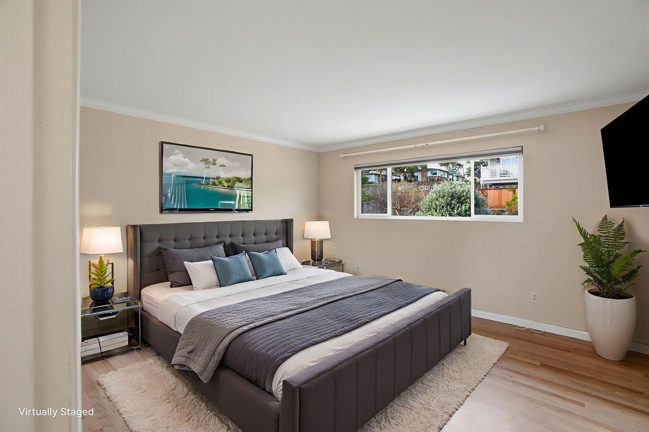 701 Archer Street Monterey, CA 93940 - Photo 14 of 39 a bedroom with a large bed and a potted plant