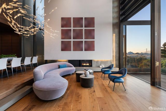 a living room with furniture a rug and a floor to ceiling window
