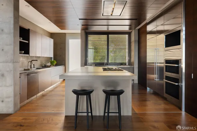 a kitchen with stainless steel appliances kitchen island granite countertop a sink and cabinets